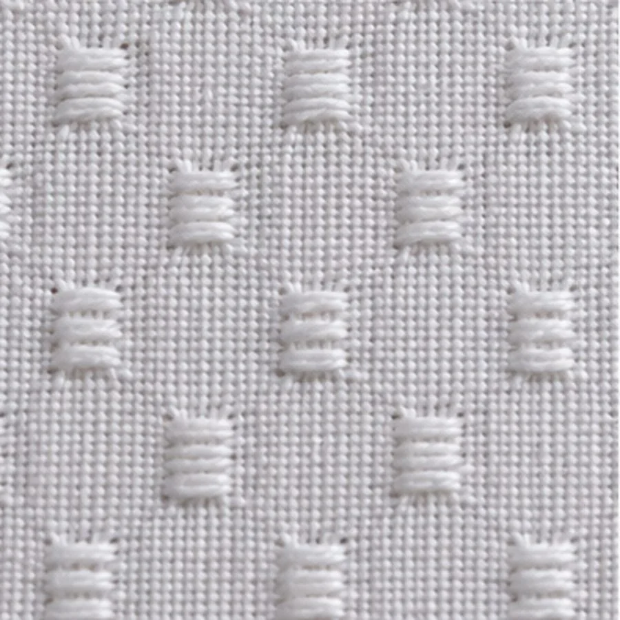 White cotton dobby, small woven figures repeating across a plain ground