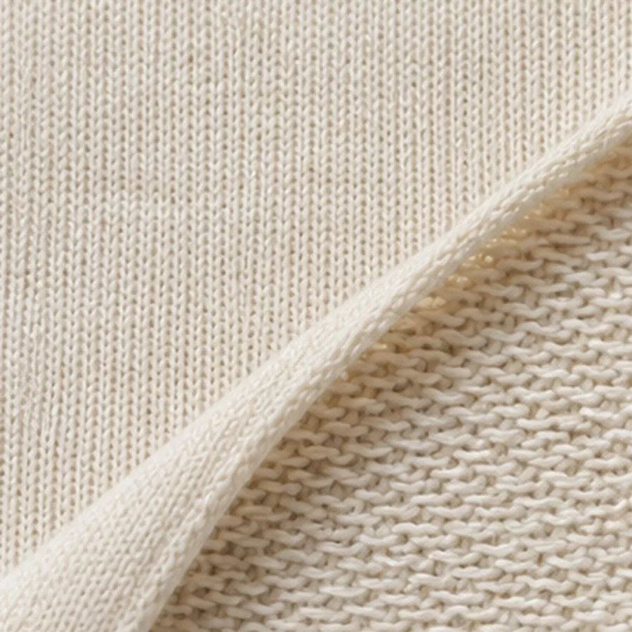 Cream French terry, the smooth face turned back to show its flat looped reverse